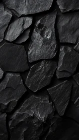 Midnight slate fragments forming a quietly bold mosaic wall.