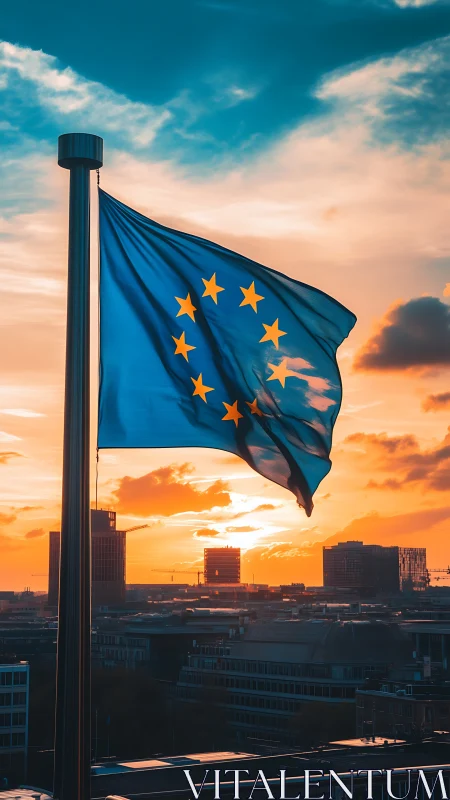 European Union flag waves above city at vivid sunset.