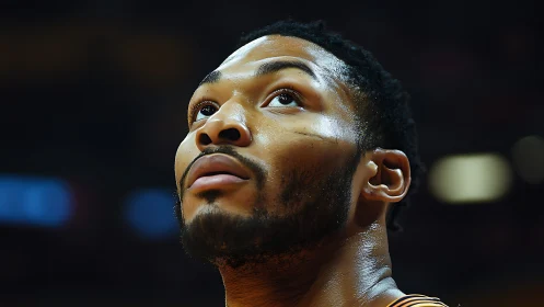 Focused basketball player looks upward with quiet determination