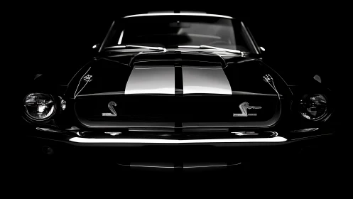 Muscle car front view emerges from dramatic black background.