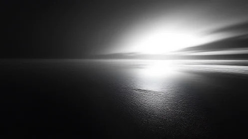 Gentle monochrome sunrise glowing over a calm open sea.