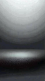 Minimalist metallic stage with vignette spotlight gradient.