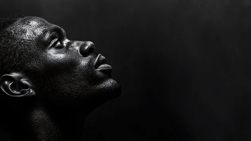 Profile portrait with dramatic side light on textured skin.