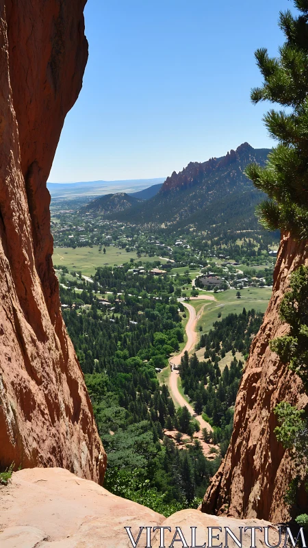 Red rock gap overlooks winding road and forested valley