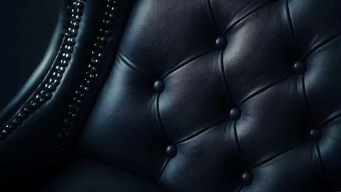 Luxurious Close-Up of Black Leather Chesterfield Chair Upholstery.
