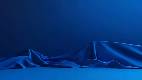 Deep blue draped fabric forming smooth abstract landscape.