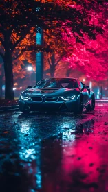 Electric coupe under neon trees on rain-soaked avenue.