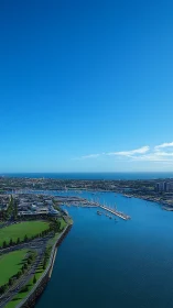 Coastal marina with moored yachts under clear blue sky.