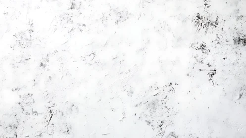 Textured white plaster surface with sparse grayscale abrasion marks.