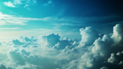 Sunlit cumulus cloudscape under deep blue sky.