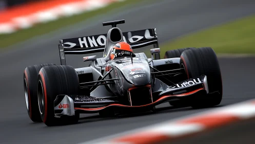 Black Formula race car attacking fast circuit corner at speed.