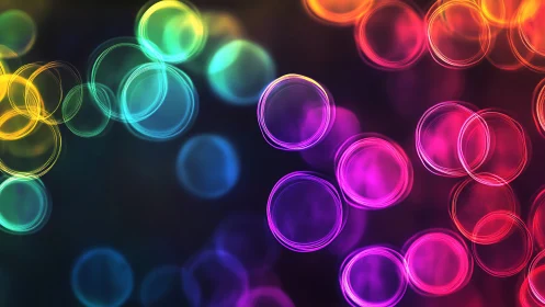 Colorful circular bokeh rings on dark gradient background.