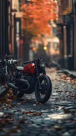 Café racer motorcycle on cobblestone alley with autumn bokeh.