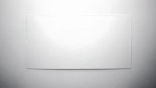 Minimalist blank white canvas against soft gray wall.