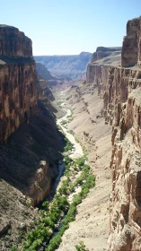 Sheer sandstone canyon walls framing meandering desert river