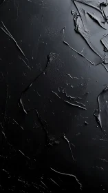 Textured black surface with scraped matte and glossy relief patterns