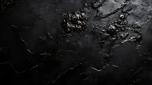 Dark textured black surface with glossy rough patches.