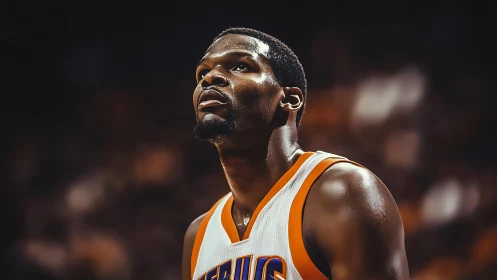 Intense basketball portrait isolates athlete under arena lights
