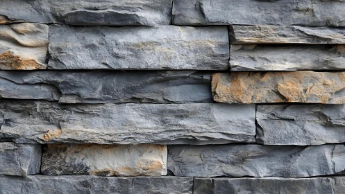 Close-up of stacked natural stone wall with rustic texture.