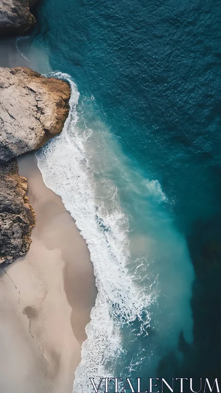 Aerial coastal interface of granite cliffs and littoral surf.