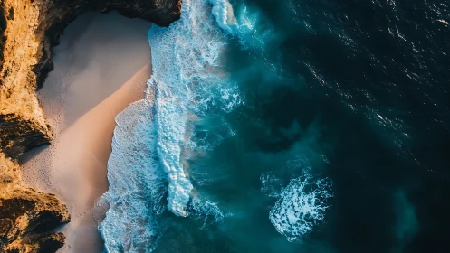 Aerial shoreline with breaking waves against golden sea cliffs