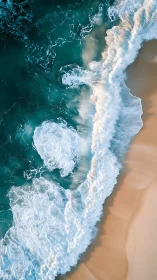 Gentle turquoise waves greeting a soft, sandy shoreline.