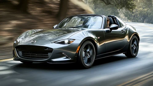 Metallic roadster cuts through wooded canyon curves at speed.