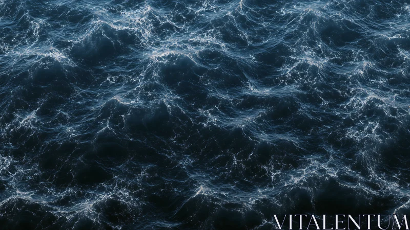 Ocean surface waves form intricate textured dark pattern.