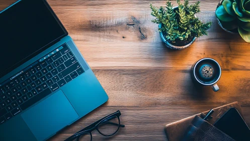 Laptop on wooden desk with coffee, plants, glasses, wallet.