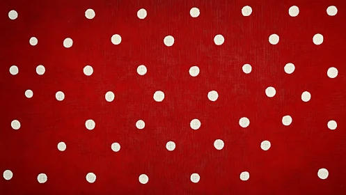 White polka dots align across saturated red textile field