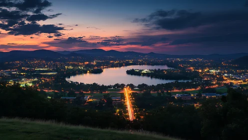 Evening city panorama frames illuminated lakeside infrastructure