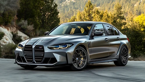 BMW M3 sedan in metallic gray parked on mountain roadway.