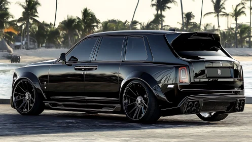 Black luxury SUV parked on coastal promenade at dusk.