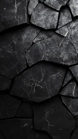 Fragmented dark stone surface with irregular cracked plates.