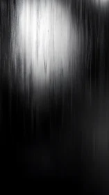 Silver rain whispers down a midnight wall of polished shadow