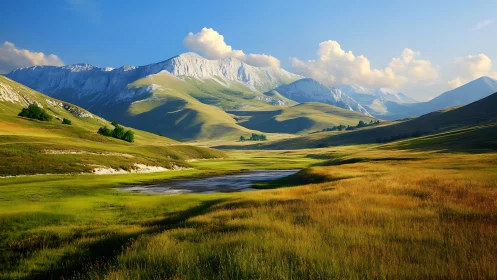 Sunlit alpine valley cradled by luminous snowlit peaks.
