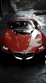 Crimson BMW concept coupé under moody wet courtyard light.