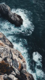 Vertical aerial view maps wave turbulence along rugged limestone coast