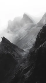 High-contrast monochrome ridgeline engulfed in atmospheric fog