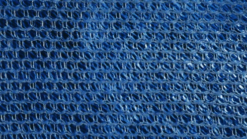 Cerulean mesh tapestry weaving metallic loops of light.