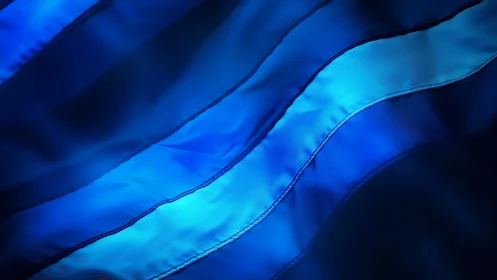 Abstract close-up of layered blue fabric folds.