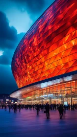 Stadium facade glows with vivid geometric red panels.
