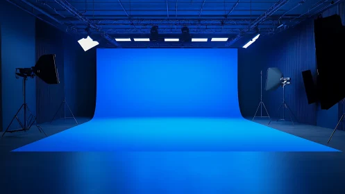 Large blue cyclorama studio with professional lighting setup.
