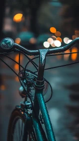 Wet bicycle handlebars with bokeh city lights in atmospheric evening.