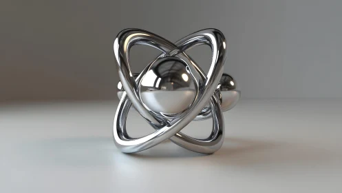 Polished chrome atom sculpture rests in soft studio light
