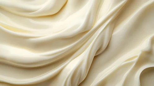 Smooth cream texture in close-up, abstract flowing folds design.