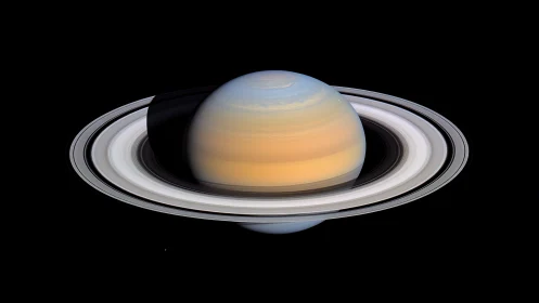 Saturn’s luminous rings drift through velvet cosmic silence.