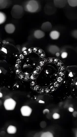 Diamond encrusted infinity charm rests among dark beads