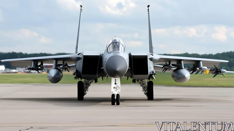 Modern fighter jet rolls along runway in ready formation.