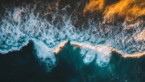 Shoreline surf and golden dusk light from above.